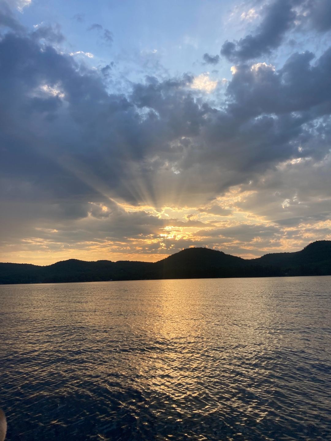 Sunset with crepuscular rays over Lake Winnipesaukee, New Hampshire